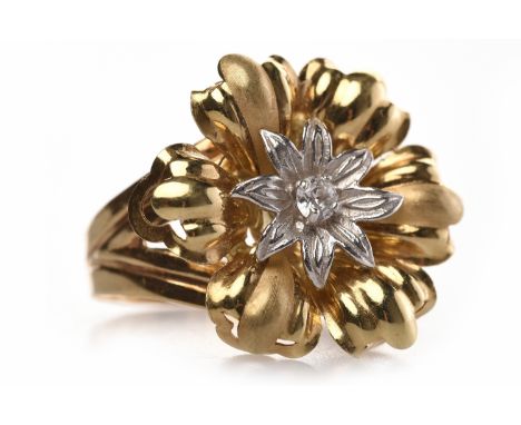 EIGHTEEN CARAT GOLD DIAMOND SET FLORAL MOTIF RINGthe floral motif bezel 23.5mm wide and with a single round brilliant cut dia