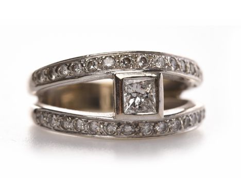 FOURTEEN CARAT WHITE GOLD DIAMOND DRESS RINGformed by two diamond set bands with a central connecting single princess cut dia