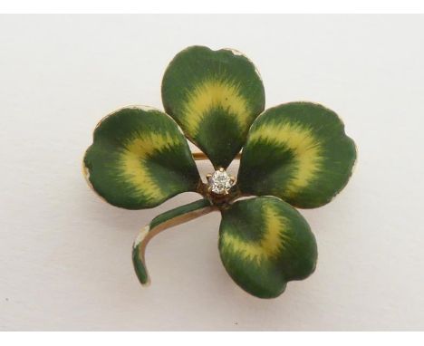 A diamond and enamel four leaf clover brooch,  set to the centre with an old cut brilliant, 2cm wide, stamped '14k' verso, 3.