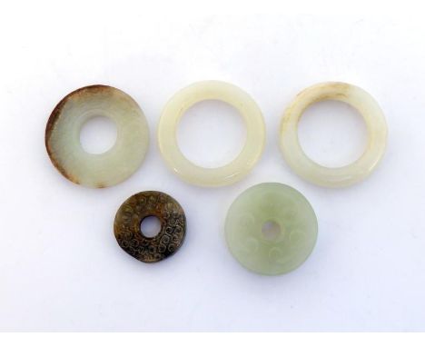 A group of three Chinese jade carved Bi and a pair of Chinese white jade carved ring attachments, carved Chi dragon on both s