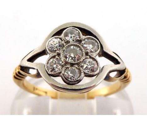 A diamond daisy cluster ring, the cluster composed of seven old brilliants, totalling approx. 0.35 carat, milligrain set, to 