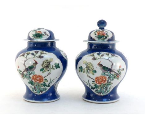 A pair of Chinese famille verte porcelain vases, panels decorated on blue ground, trees, flowers and birds inside the panel. 