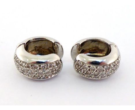 A pair of French 18 carat white gold and diamond earrings, the half hoops each with a panel of pave set brilliants, French po