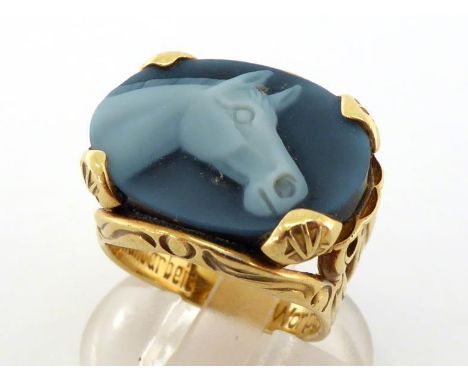 A glass cameo signet ring, the oval cameo depicting the head of a horse, 20 x 14.8mm, to bifurcated shoulders, the mount (tes