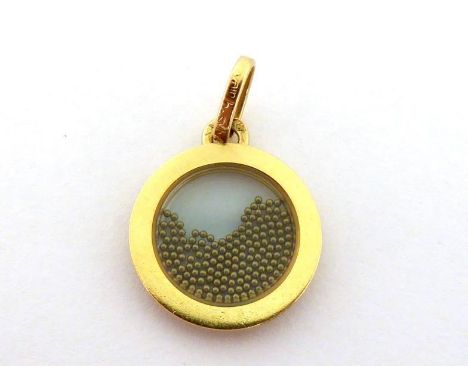 A French 18 carat gold pendant by Bernard Sylvain, Paris,  the small circular pendant with floating gold pellets within a cen