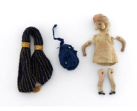 A small bisque headed doll with ceramic limbs and blonde hair, original clothing and ornate lace trimmed bonnet, complete and