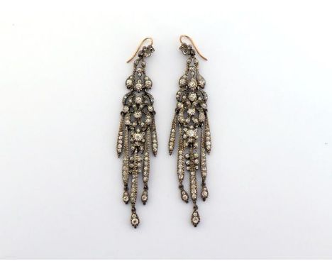 A pair of early 20th century paste set chandelier earrings,  each mounted in silver, with gold hook fittings, 9cm long CONDIT