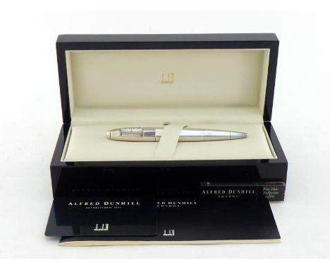 DUNHILL, a faceted silver 'Torpedo' limited edition ballpoint pen with clock, no. 89/350, the signed white dial and mechanism