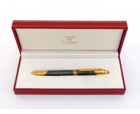 Cartier, Cougar, a gunmetal grey and gold plated rollerball pen, with Trinity band and onyx cabochon cap jewel, in its box CO