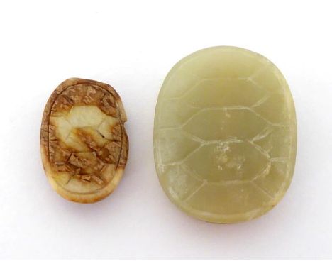 Two small Chinese jade attachments, each carved as a turtle carapace in pale celadon and brown colour, 19th/20th century, 3cm