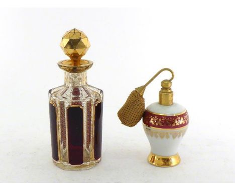 A Venetian hexagonal cut glass scent bottle with ruby overlay panel cut and finely gilt, ht.15cm., complete with original pap