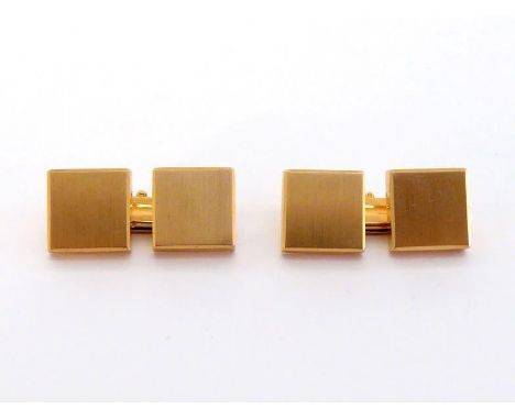 A pair of yellow metal (tests 18 carat gold) cuff links, the square brushed gold links 8 x 8mm, 9.7gms, in a fitted MASSONI b