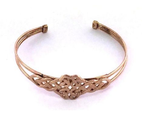 A 9 carat gold bangle, with central knot motif, fully hallmarked, 6.1gmsCONDITION: split to one arm at the shoulder of the ba