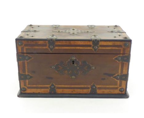 A Victorian brass bound mahogany casket with pierced and riveted strap mounts and inlaid with burr walnut. One strap mount mi