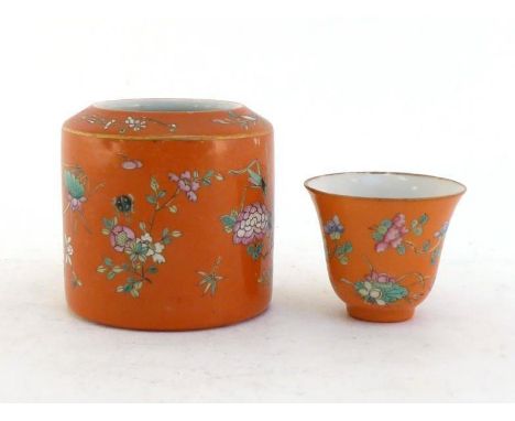 A Chinese porcelain famille rose wine cup and warmer pot, both decorated with insects and floral design on coral ground. Iron