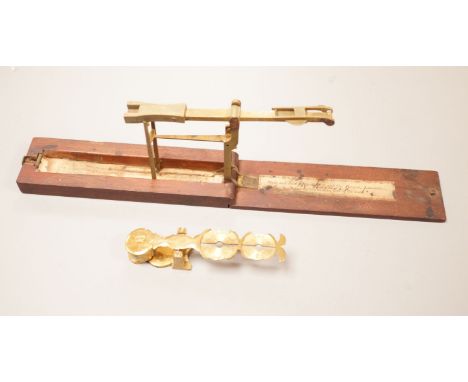 Two sets of gold / coin scales, together with a 1/2 pistol and 1 Guinea