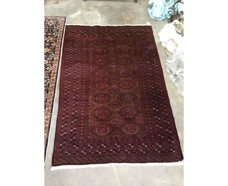 A Bokhara red ground carpet, 230cm x 152cm