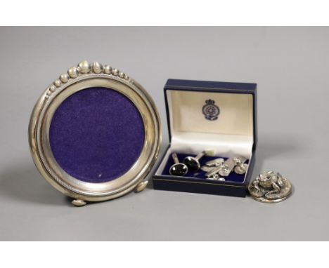 A pair of silver and black enamel cufflinks, two pairs of white metal cufflinks, a small silver overlaid frog paperweight and