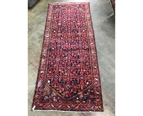 A North West Persian blue ground hall carpet, 304 x 127cm