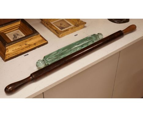 A Victorian glass rolling pin together with a turned wooden example, widest 82cm (2)