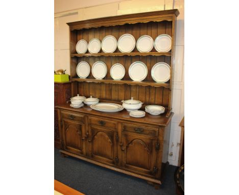 A reproduction oak Welsh dresser with two shelf panelled back, on base with three drawers and panelled cupboards, 155cm