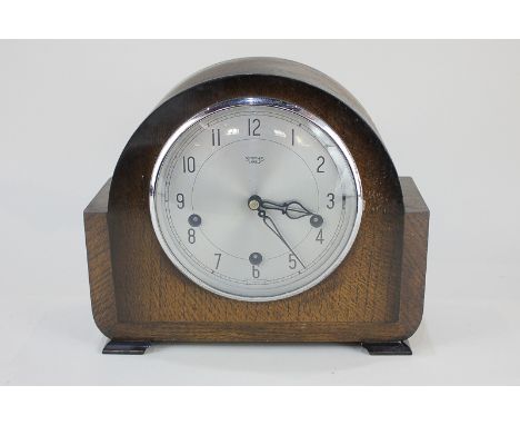 An Art Deco Smiths of Enfield mantel clock with silvered dial, in dome case, 27cm