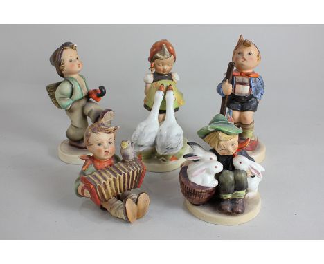 A collection of five Goebel Hummel porcelain figures of children in various pursuits