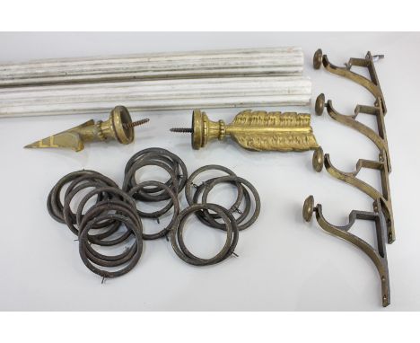 A wooden curtain pole, 142cm long, with gilt brass arrow stoppers and wooden curtain rings, together with another identical c