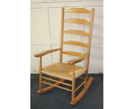 A ladder back rocking chair with rush seat