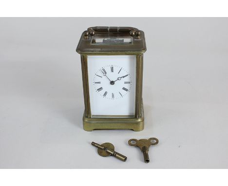 A brass and bevelled glass cased carriage clock with Roman numerals (a/f)