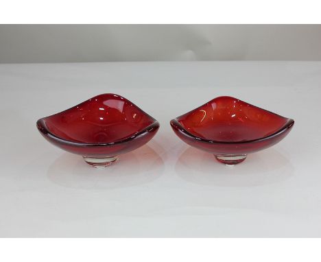 A pair of Whitefriars ruby red glass bowls of trigonal form, designed by Geoffrey Baxter (pattern 9516), label to base, 7cm h