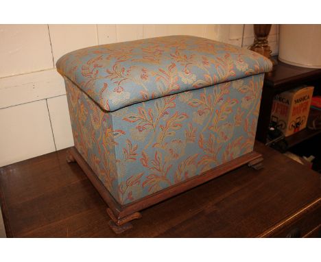 An upholstered Ottoman seat with rising top, on wood framed base and bracket feet, 55cm