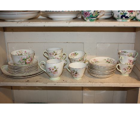 A Royal Doulton Apple Blossom pattern part tea service comprising nine cups and saucers, side plates, cream jug, sugar bowl a