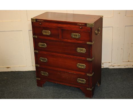 A campaign style brass bound bachelor's chest with fold-over top, pull-out slide and two short over three long drawers below,