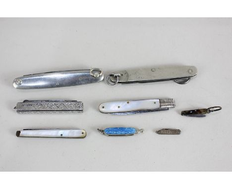 A Victorian silver fruit knife and button hook, a silver and mother of pearl fruit knife, two penknives, two miniature or toy
