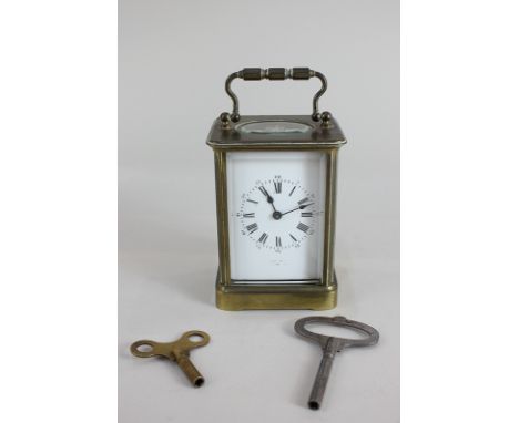 A brass and bevelled glass cased carriage clock, the dial with Roman numerals and faded name, 14cm high