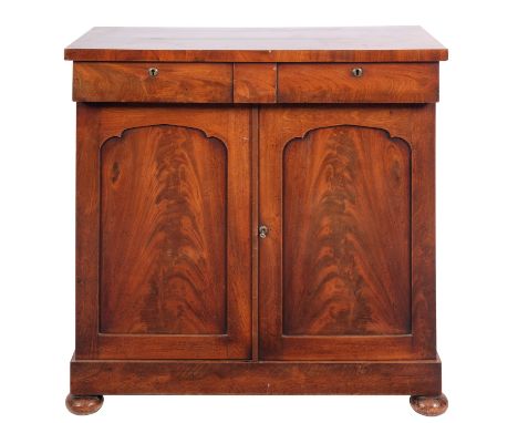 A Victorian mahogany chiffonier, circa 1880; with two frieze drawers above twin shallow arched panel doors; on bun feet; 89cm
