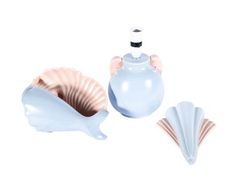 Three pieces of Poole Pottery twin-tone, in turquoise and pink, comprising a lamp, a Deco style wall pocket and a conch shell