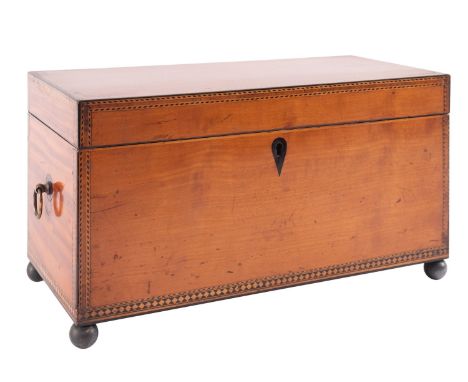 A satinwood and inlaid box, previously a tea caddy, early 19th century; with a brass ring handle at each end and on spherical