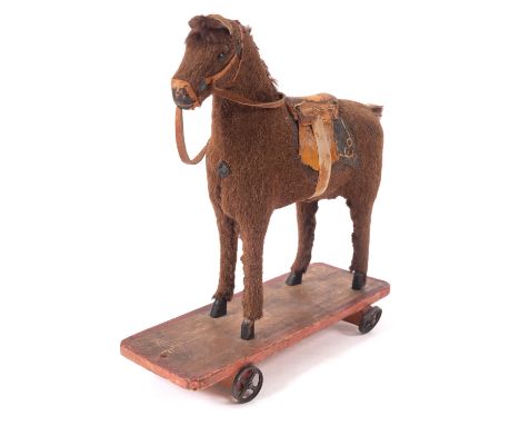 A late 19th/ early 20th century pull along horse, the brown fabric horse with boot button eyes,  applied hair ear mane and ta