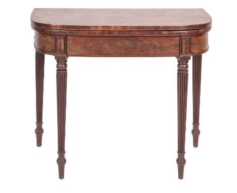 A Regency mahogany card table, circa 1815; the 'D' section hinged top opening to a later baize lined interior; the reeded leg