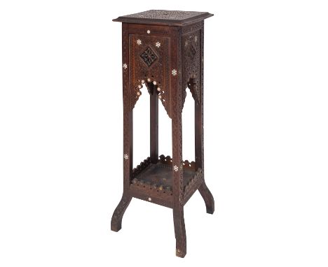 A Levantine carved hardwood and mother-of-pearl inlaid stand, early 20th century; the square top with stylised scrolling foli