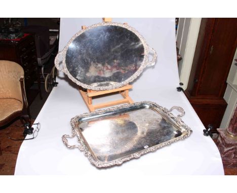 Two large silver plated serving trays with heavily embossed edges