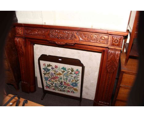 Carved mahogany fire surround, granite back plate and needlework panel firescreen (3)
