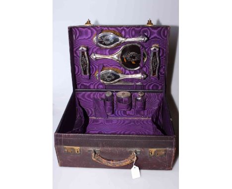 Early 20th Century travelling vanity case containing silver and tortoiseshell brushes, mirror and bottles