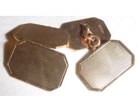 A pair of 9 carat gold engine turned cufflinks of rectangular form with cut corners, approx 6.7 g