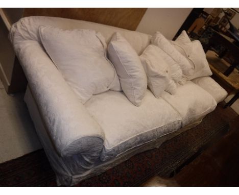 A modern cream floral design upholstered scroll arm sofa on turned legs  Size approx. 240cm long x 75cm high x 99cm deep