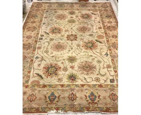 A modern Persain style carpet, the central panel with all over floral decoration on a cream ground within a stepped cream, ye