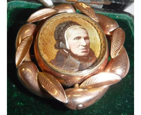 A Victorian yellow metal mounted mourning brooch set with hair to back and hand-painted photographic portrait of a lady, appr