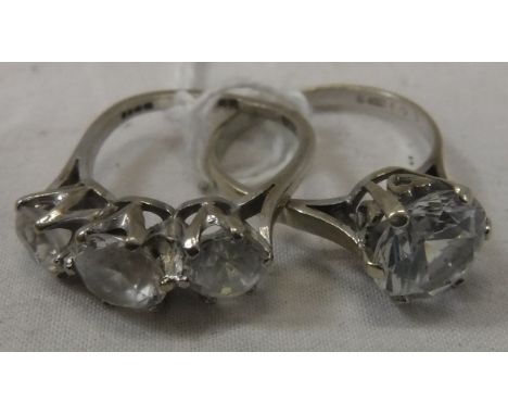 An 18 carat white gold three stone set dress ring, size L approx 4.4 g total, together with a further 9 carat white gold ring